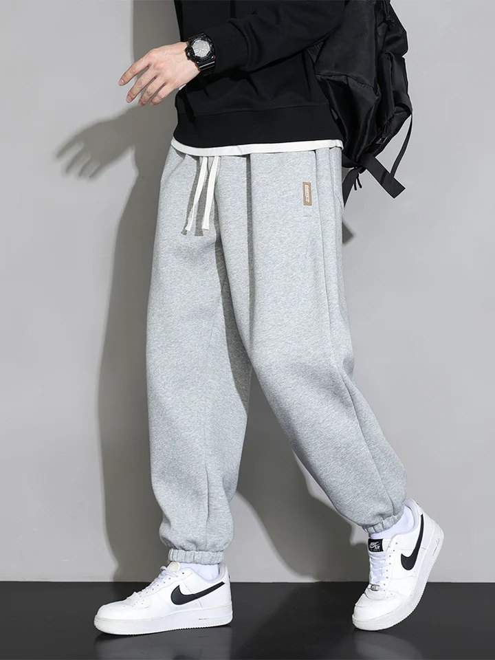Plus veľkosti pánske tepláky 8xl 7xl 6xl športového oblečenia Elastické pasáre Príležitostné vreckové nohavice Čierne šedé bavlnené joggery Mužské voľné nohavice